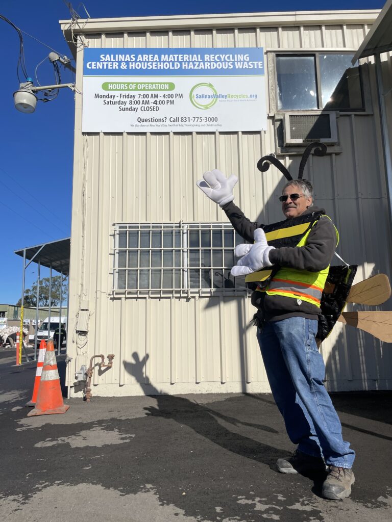 "Free Bee" pointing to sign at Madison Lane Recycling Center