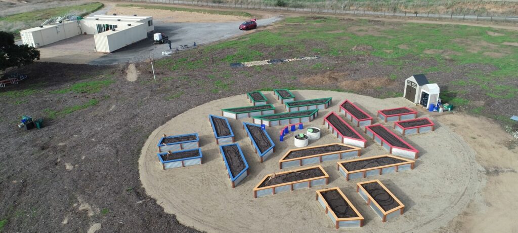 Photo of raised Garden beds and Ed Center.